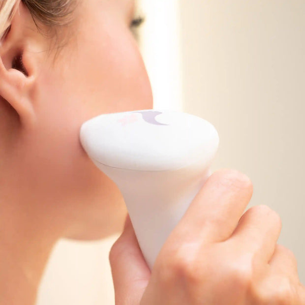 Using the lucky skin hydro device on your cheek.