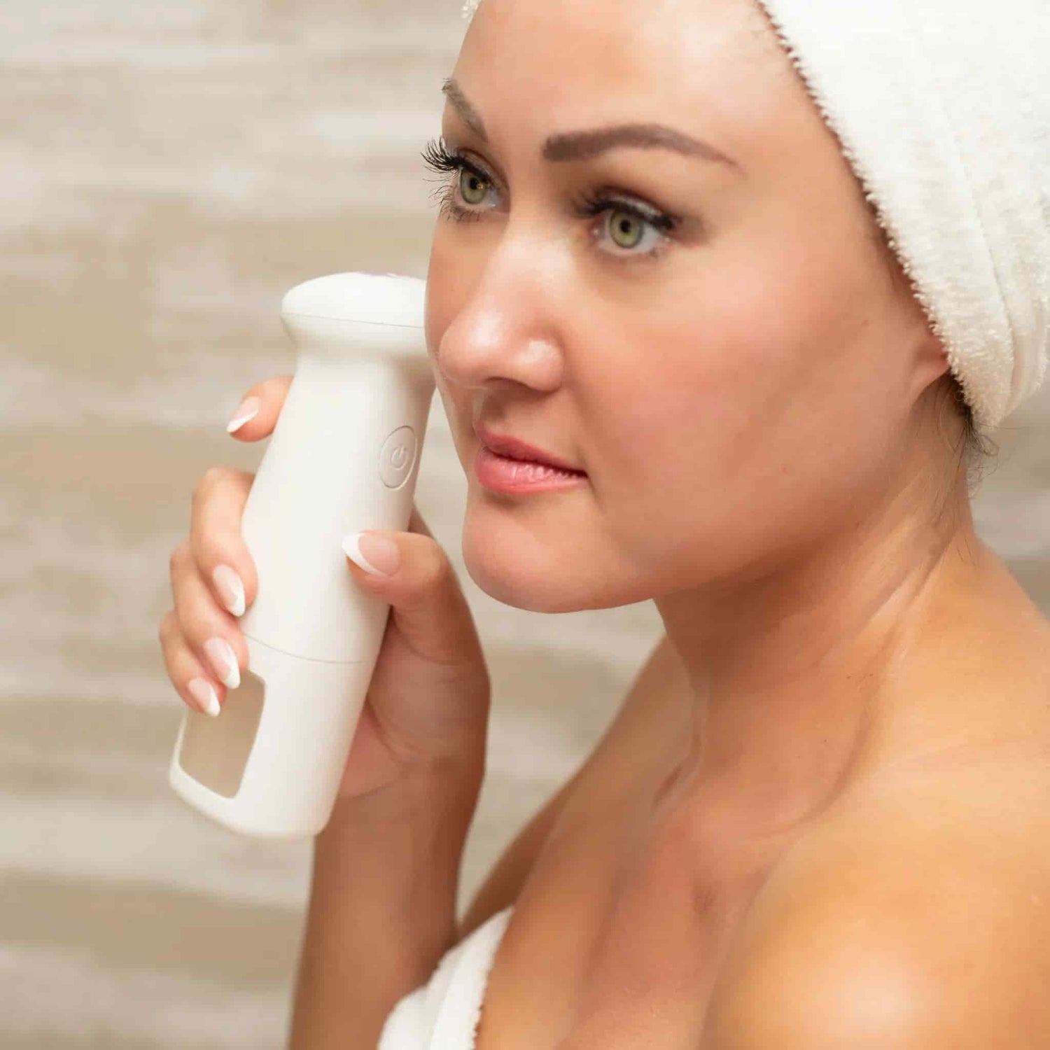 Woman using the lucky skin hydro device after a shower