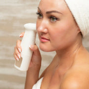 Woman using lucky skin hydro device after a shower